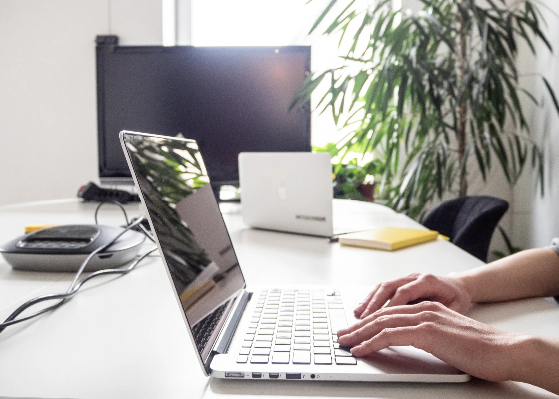 A close-up of hands by the laptop in the Untitled Kingdom office.